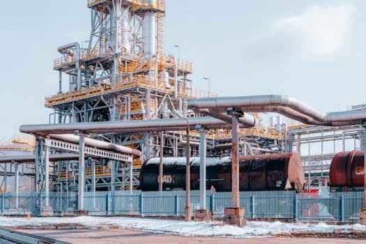 Oil refinery facility with tanker wagons in Trzebinia, Lesser Poland Voivodeship under a clear sky.
